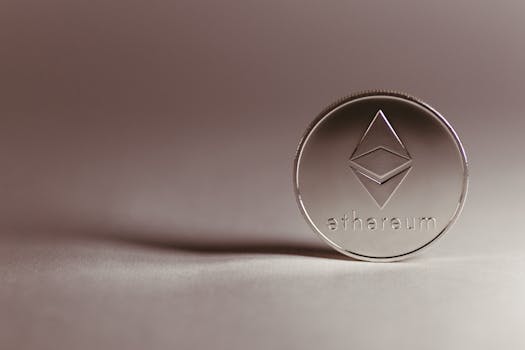 Close-up of a silver Ethereum coin symbolizing digital currency and blockchain technology.