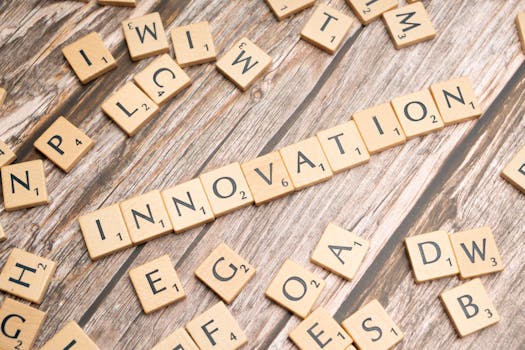 Creative display of 'Innovation' spelled with wooden letter tiles on a wooden surface.